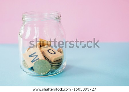 the future of Finance, business banking and financial concept. Flatlay Euro cents and cubic letters inside glass jar on two color background.