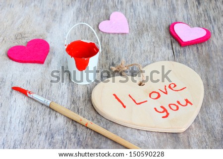 red paint brush Love heart romantic vintage wooden background.