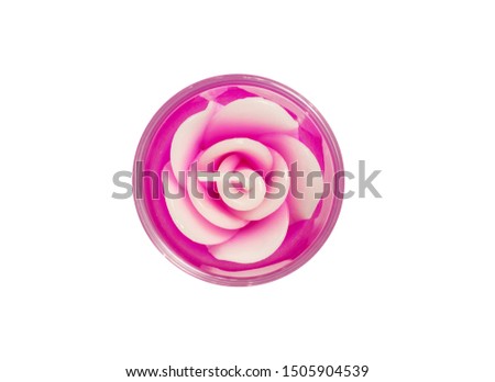 Closeup top view of candle in rose shape isolated on white background