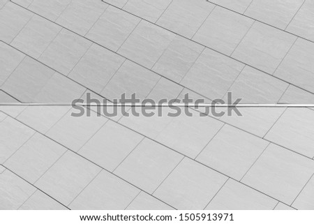 Light gray tile with joing on wall background for exterior design.