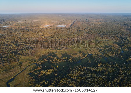 Aerial photography with a drone. Landscape with green forest, road and river