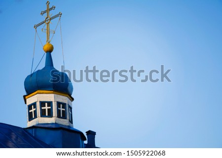 blue dome with a gold cross of the old Orthodox Church. the blue roof of the Church against the sky.
