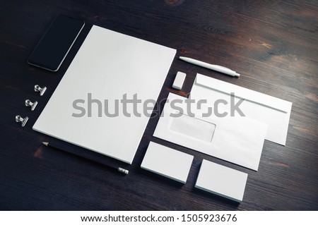 Photo of blank stationery set on wood table background. Corporate identity template. Responsive design mockup.