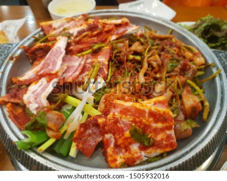 This picture is a one of the Korean main dishes. It called osam bulgogi. osam bulgogi is a Spicy  Squid and Pork Belly Bulgogi Which is made with sliced pork belly, squid, bean sprouts.