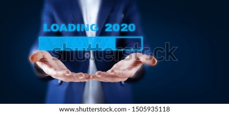 business man hand loading 2020 in screen