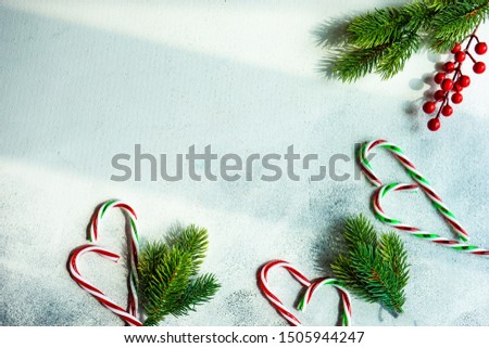 Christmas frame with candy cones on stone background with copy space
