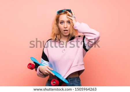 Young skater woman over isolated pink background with surprise facial expression