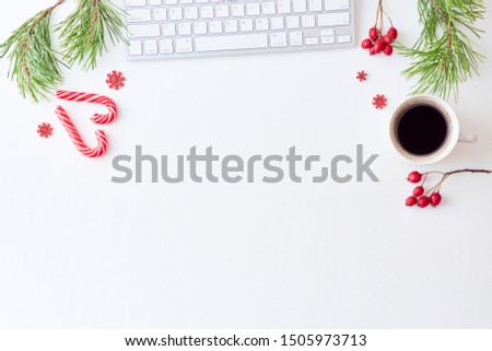 Flat lay christmas home office desk with pine branches and keyboard, christmas decorations  on a white background