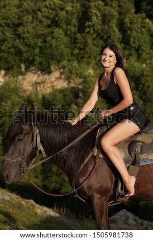 Beautiful girl with a horse in the mountains