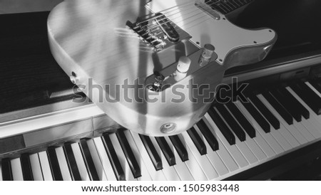 electric guitar and piano keyboard . black and white                              