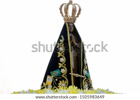 Statue of the image of Our Lady of Aparecida, mother of God in the Catholic religion, patroness of Brazil, decorated with flowers in open parade Royalty-Free Stock Photo #1505983649