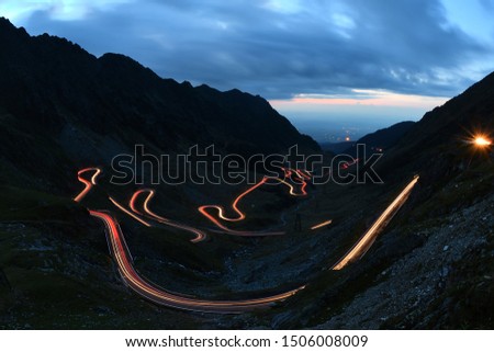 Traffic trails on Transfagarasan pass at night. Crossing Carpathian mountains in Romania, Transfagarasan is one of the most spectacular mountain roads in the world Royalty-Free Stock Photo #1506008009