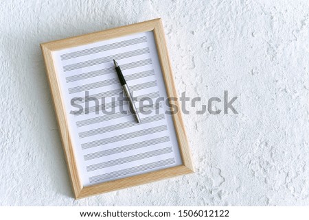 frame with notes hanging on a white wall.