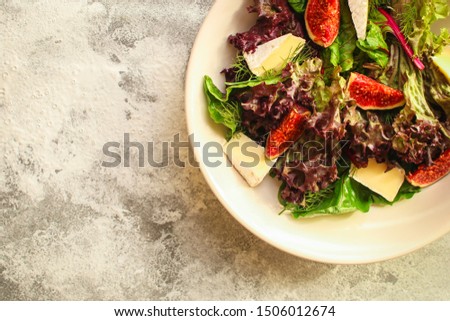 healthy salad mix leaves, figs, cheese (tasty snack, vitamins, healthy food) menu concept. food background. copy space. Top view