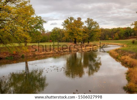 Muskau Park and Neisse river at autumn morning. German-Polish border. Ducks on the water. UNESCO World Heritage Site