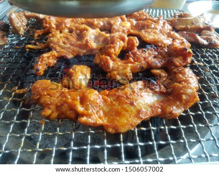 This picture is Korean style spicy grilled chicken. This food is called Dak-galbi. Dak-galb is grilled on a charcoal barbecue.
