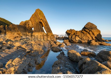 stone arch at blackchurch rock, mouthmill beach, north devon Royalty-Free Stock Photo #1506057377