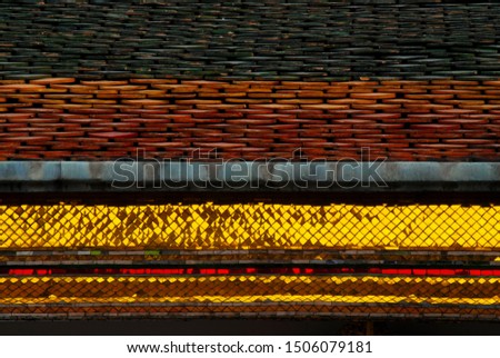 close-up on roof of Thai temple in black-red-gold