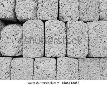 A photograph on gray bricks with a black and white filter can be used as a decorative background or as a texture.