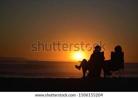 Relaxing on a beautiful evening at the beach while gazing at a jaw dropping sunset