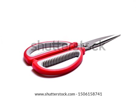 Scissors, red-gray handle made of Hardened steel, able to cut thin sheet metal isolated on white background.