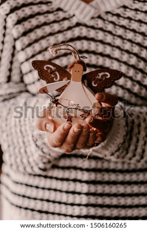 Vintage Christmas tree ornament in woman hands. Christmas mood and atmosphere. Blurred photos, bokeh.