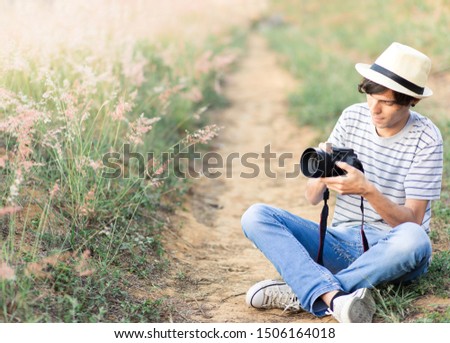 young man taking pictures of nature
