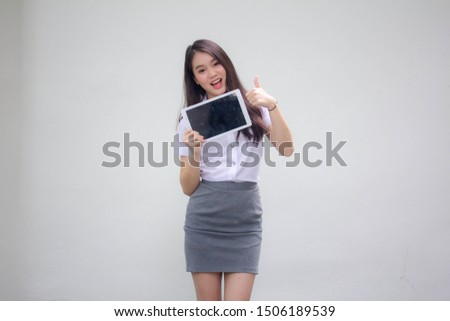 Portrait of thai adult working women white shirt show her tablet.