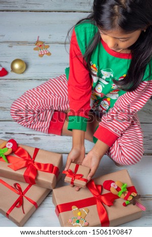 Cute brunette girl with her presents on Christmas day