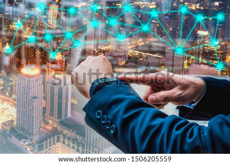 Businessman point on smart watch hi technology 4.0 to connect communication network data for success project in business technology concept.