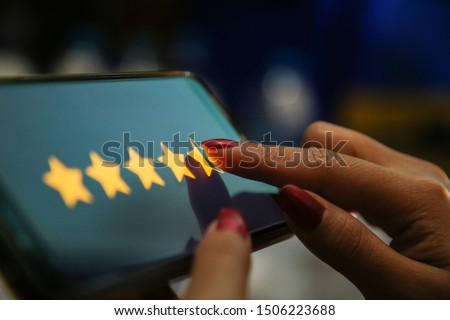 hands showing four point five stars on a smart phone