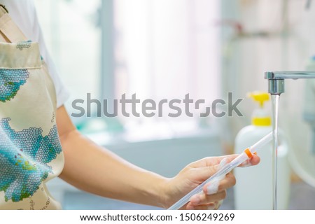 Woman using brush for drinking straw cleaning. Selective focus. Copy space. 