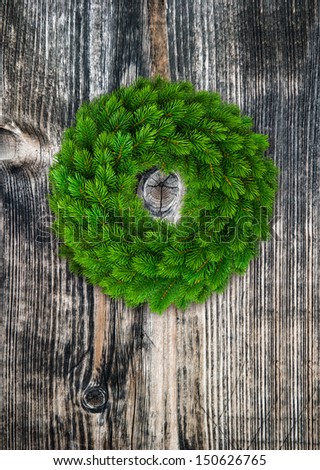 green christmas wreath over rustic wooden background