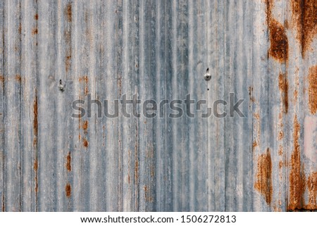 Closeup of old zinc sheet partition with rusted texture in vertical column.Rusted galvanized iron texture.