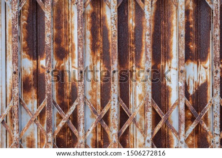 Close up of old rusted door in vintage style use for texture and background.Grunge steel foldable door.