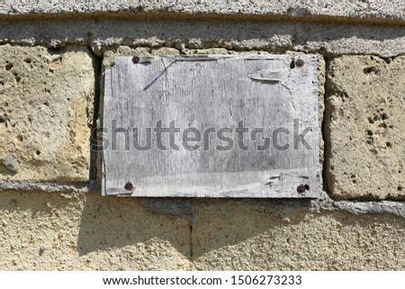 wooden plate on a brick wall ready for text