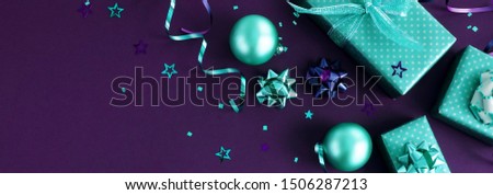 Christmas background banner. New year  decorations frame on violet backdrop top view with copy space. Trend color 2022 Velvet Violet