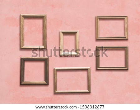 old wooden frames on pink wall