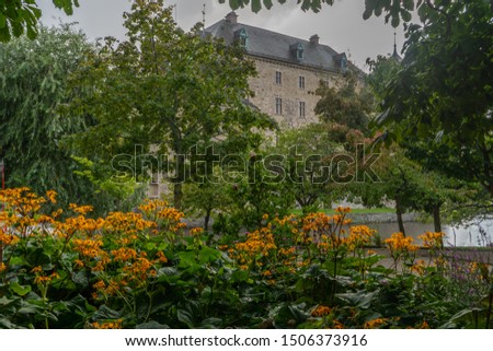 Fragment of Orebro castle with flowers and trees. Castle view from park side. Travel photo, background or illustration. 