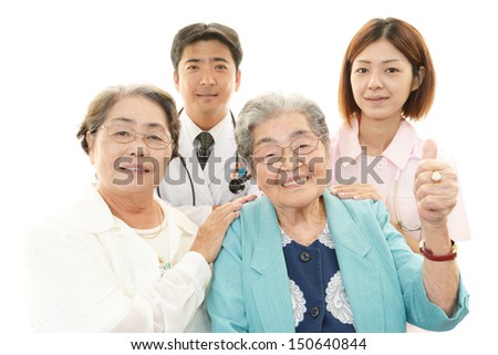 Smiling Asian medical staff with old women