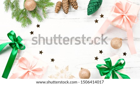 Christmas frame with fir branches, wrapped gifts in pink and green colors, confetti. Christmas flat lay, copy space