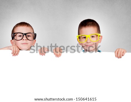 Twins holding blank red poster with blank space