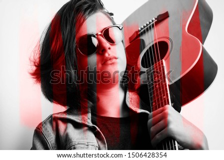 Portrait of a teenager with guitar in studio