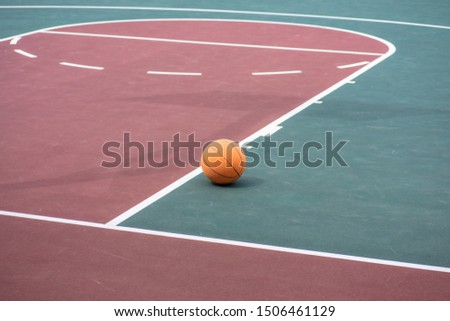 Basketball on empty court with free throw line in background