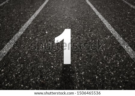 Asphalt road with Number one on the surface. An image of a milestone roadmap is a representation of success in the future goal