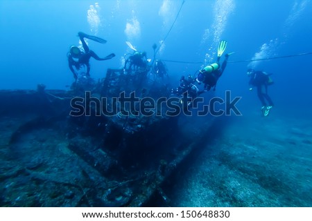 Divers and Marine shipwreck  Royalty-Free Stock Photo #150648830