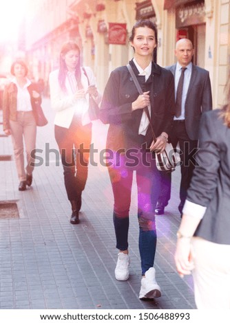 Business people in formal wear walking down street in big city