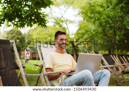 The guy is sitting in an outdoor cafe and using a laptop. LGBT population