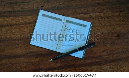 Diary note book and pen on a wooden old background top view
