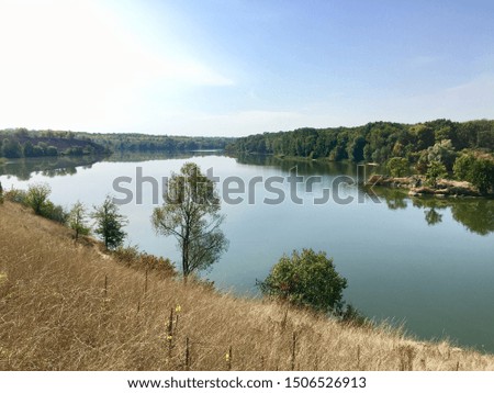Beautiful landscape of the river and trees that are reflected on the surface of the water